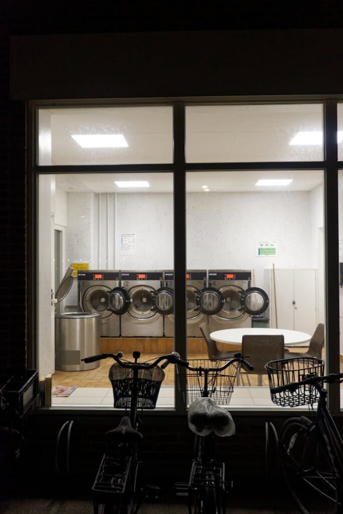 Evening view of a Copenhagen laundromat with parked bicycles outside.
